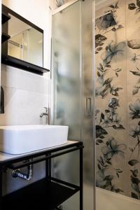 a bathroom with a sink and a shower at Gravina8 - Rooms in Naples in Naples