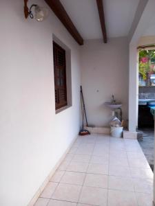Habitación con suelo de baldosa y puerta. en Appartement cosy au Vauclin - 35 m² avec balcon jardinise, en Le Vauclin