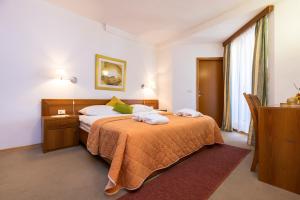 a bedroom with a bed with two towels on it at Sanpier Apartments in Veli Lošinj +42 photos