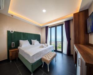 a bedroom with a large bed and a large window at Royal Villa in Trabzon