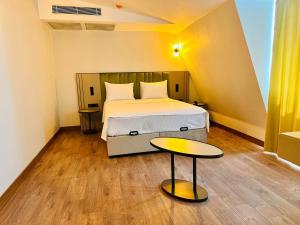 1 dormitorio con 1 cama y 1 mesa en Nice Royal Suite en Estambul