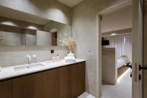 a bathroom with a sink and a mirror at Sevasti Seaview Suite in Koskinou