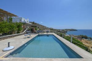 a swimming pool with a view of the ocean at Dream summer house in Tinos in Tinos Town