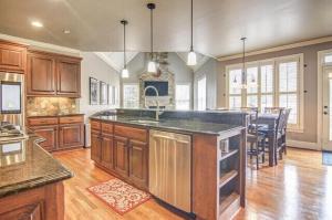 a large kitchen with a large island in the middle at The REZORT-Ideal for Exclusive Events Feat. Pool, Gym, Fire Pit & More! in Lawrenceville