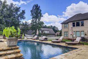 a swimming pool with lounge chairs and a house at The REZORT-Ideal for Exclusive Events Feat. Pool, Gym, Fire Pit & More! in Lawrenceville