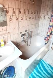 a bathroom with a bath tub and a sink at Schön und bequem Wohnung in Althengstett