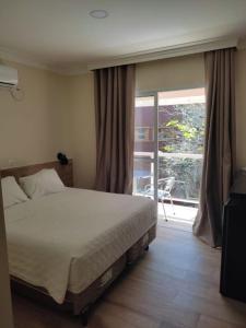 Cama ou camas em um quarto em Pousada Maresias Beira Mar