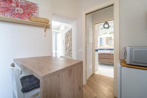 a kitchen with a wooden counter top and a microwave at La Rovettina Pet friendly house in Salò