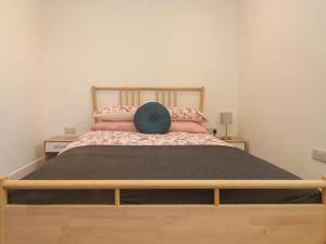 a bedroom with a large bed with pink pillows at Chapel House in Okehampton