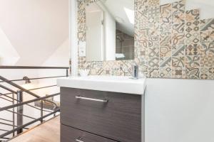 a bathroom with a sink and a mirror at La grange de Merlin in Concoret +26 photos