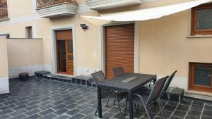 a wooden table and chairs on a patio at ALOJAMIENTO TEATRO in Ribadeo