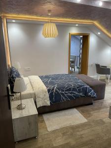 a bedroom with a bed and a table and a mirror at Villa i SPA Stević in Veliko Gradište