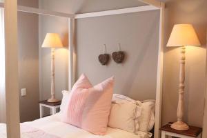 a bedroom with a large mirror and two lamps at Muller's Self Catering - a cozy home from home! in Swakopmund