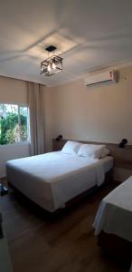 Cama ou camas em um quarto em Pousada Maresias Beira Mar