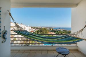 a hammock in a room with a view of the ocean at Sea Lux Ericeira in Ericeira
