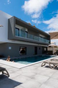 a house with a swimming pool in front of it at Ria Formosa Guest House in Faro