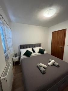 a bedroom with a large bed with two towels on it at Apartmani Mia in Drage +38 photos