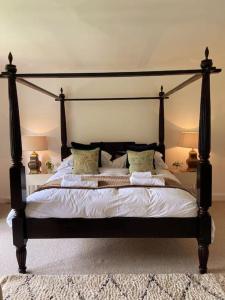 A bed or beds in a room at The Dower House at Parnham Park