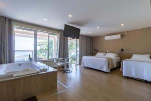 Cama ou camas em um quarto em Pousada Maresias Beira Mar