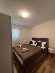 a bedroom with a bed with two towels on it at Apartmani Mia in Drage
