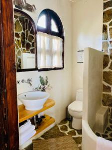 a bathroom with a sink and a toilet at Under the Tuscan Sun Cottage in West Los Angeles in Los Angeles