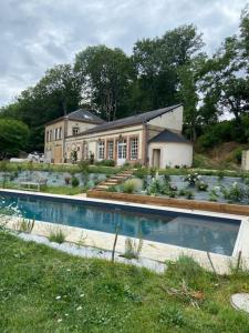 a large house with a swimming pool in front of it at maison 8 pers avec piscine en pleine nature in Ambenay