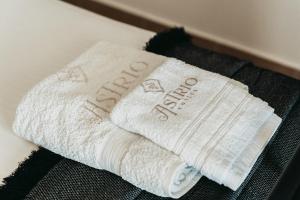 a white towel with the wordarma written on it at Astrio Suites in Livadi