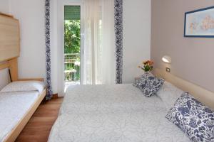 Postel nebo postele na pokoji v ubytování Hotel La Gioiosa