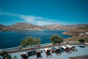 a view of a large body of water with lounge chairs at Astrio Suites in Livadi