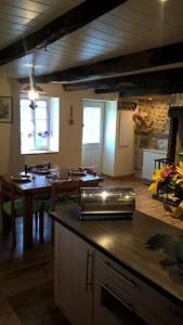 a kitchen with a table and a counter top at Maison de campagne in Sénergues