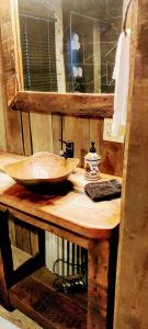 a wooden counter with a bowl on top of it at Hocking Hills Rusty Lofts in Logan