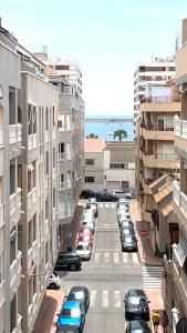 a group of cars parked in a parking lot between buildings at ApartalMar in Torrevieja