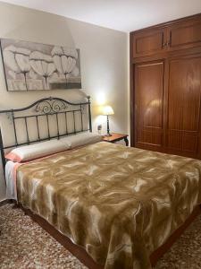 a bedroom with a large bed and a dresser at Bright flat with view to the Castle and the Museum in Alicante