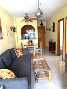a living room with a couch and a table at ApartalMar in Torrevieja