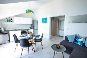 a kitchen and a living room with a table and chairs at Lux Gradac in Gradac +13 photos