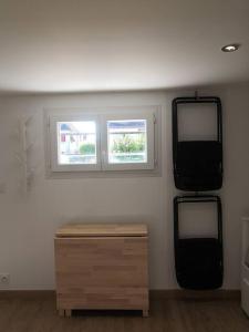Habitación con 2 espejos y mesa de madera. en Le studio lamottois, en Lamotte-Beuvron