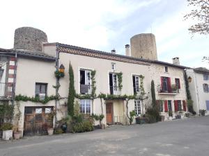 a building with two towers on top of it at Hôtel Saint Laurans in Aurignac