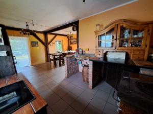 a kitchen with an island in the middle of a room at Śródziemie Gondor in Leśno
