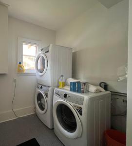 a washing machine and a washer in a laundry room at OH Victoria Hotel - Red Beard Suite 2B 2BTH in Hampton 