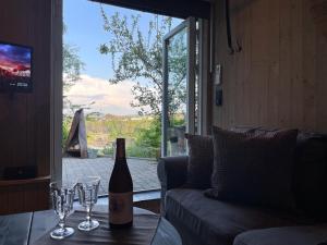 a bottle of wine sitting on a table with wine glasses at Apartments Bergen with sea view! in Bergen