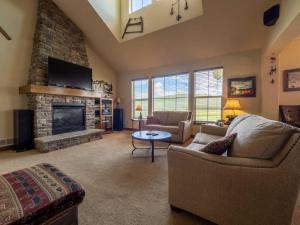 a living room with a couch and a fireplace at Fairview 2 in Granby