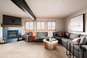 a living room with a couch and a fireplace at Mod MTN Must - Steps from Shuttle - Silverthorne in Silverthorne