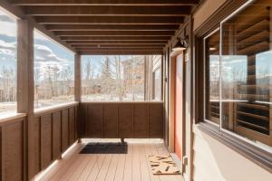 a screened porch with a view of the snow at Mod MTN Must - Steps from Shuttle - Silverthorne in Silverthorne