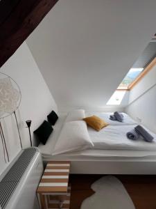 a large bed in a room with a window at Emerald Valley Apartments in Bovec