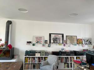 a living room with a book shelf filled with books at Ecole des hautes cotes in Fussey