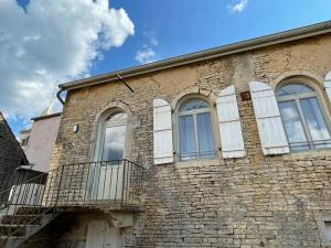 a brick building with white doors and windows on it at Ecole des hautes cotes in Fussey