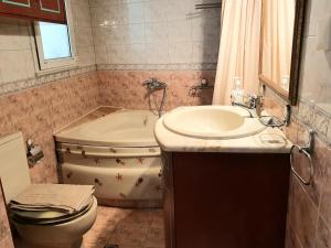 a bathroom with a sink and a toilet and a tub at Gallery Art Loft, Chania, Crete in Chania