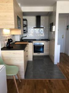 a kitchen with wooden cabinets and a stove top oven at A Estrenar. Apartamento Reformado con vistas. in Salinas
