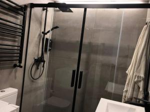 a shower with a glass door in a bathroom at A Estrenar. Apartamento Reformado con vistas. in Salinas