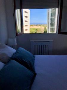 a bedroom with a bed with a large window at A Estrenar. Apartamento Reformado con vistas. in Salinas